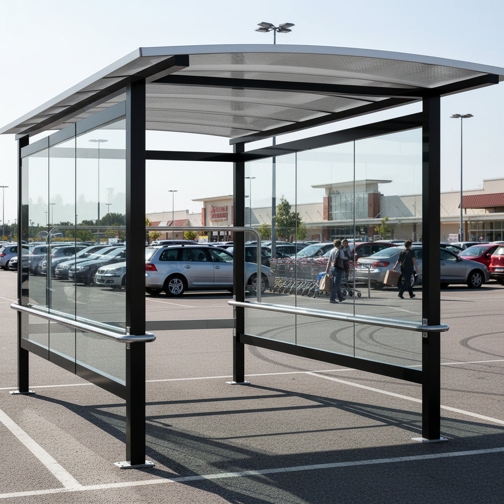 Rear angle of shopping cart shelter with curved roof and full glass back panel.