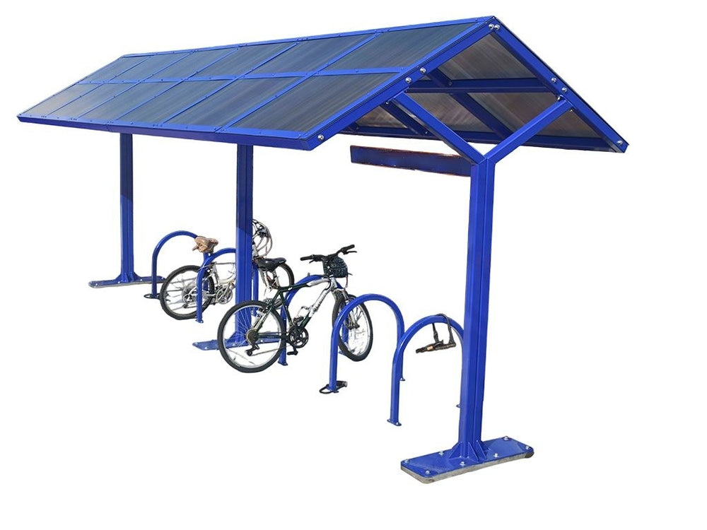 A blue bike shelter with a translucent roof and glass side panels, featuring a steel post and bike racks underneath.