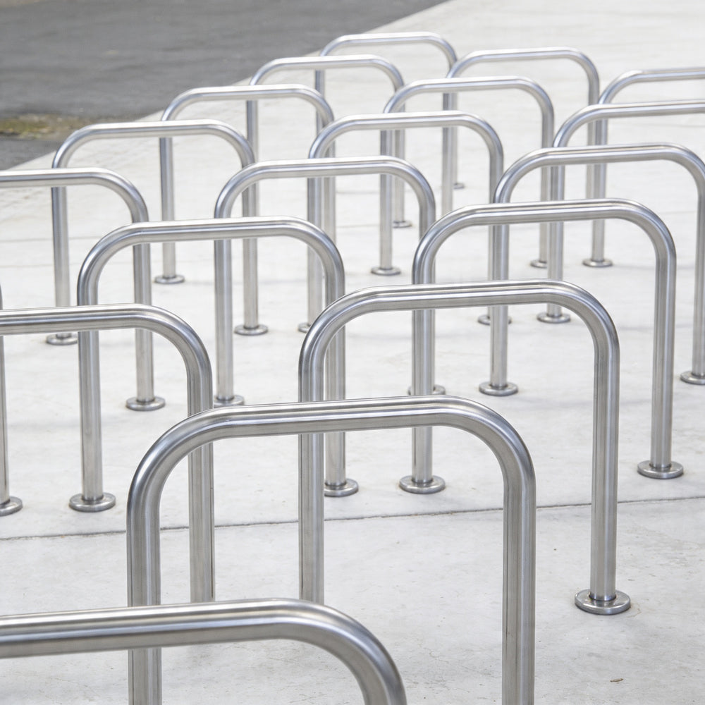 Row of metal bike racks on a concrete surface