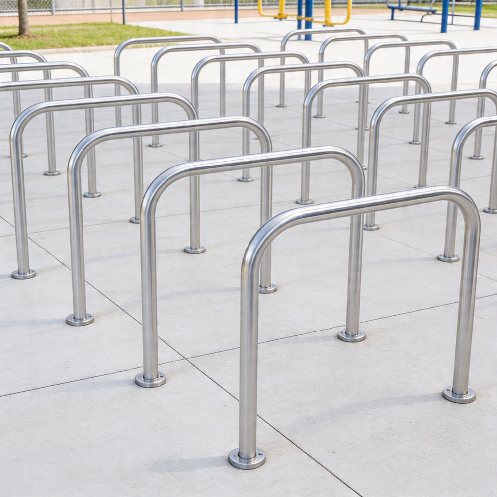 Row of metal bike racks on a tiled pavement
