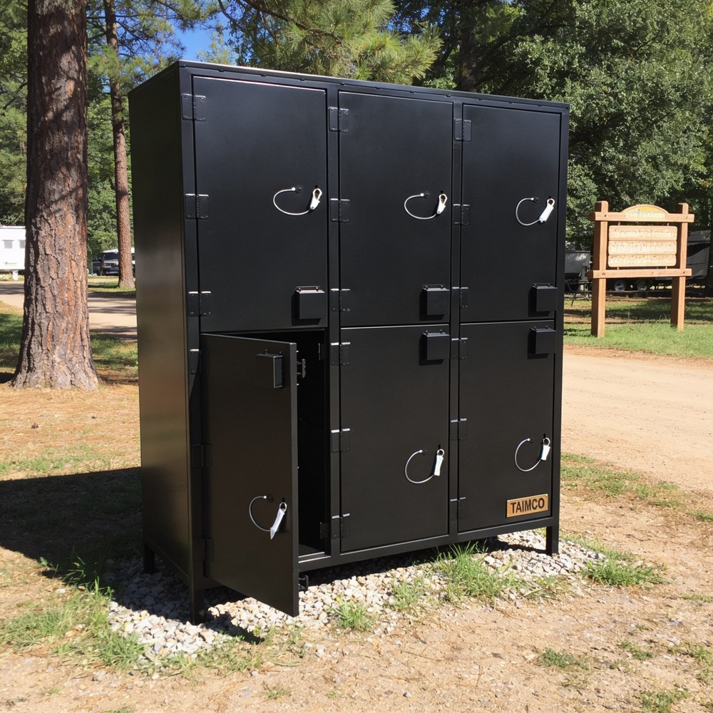 Black metal locker unit with open door in a park setting