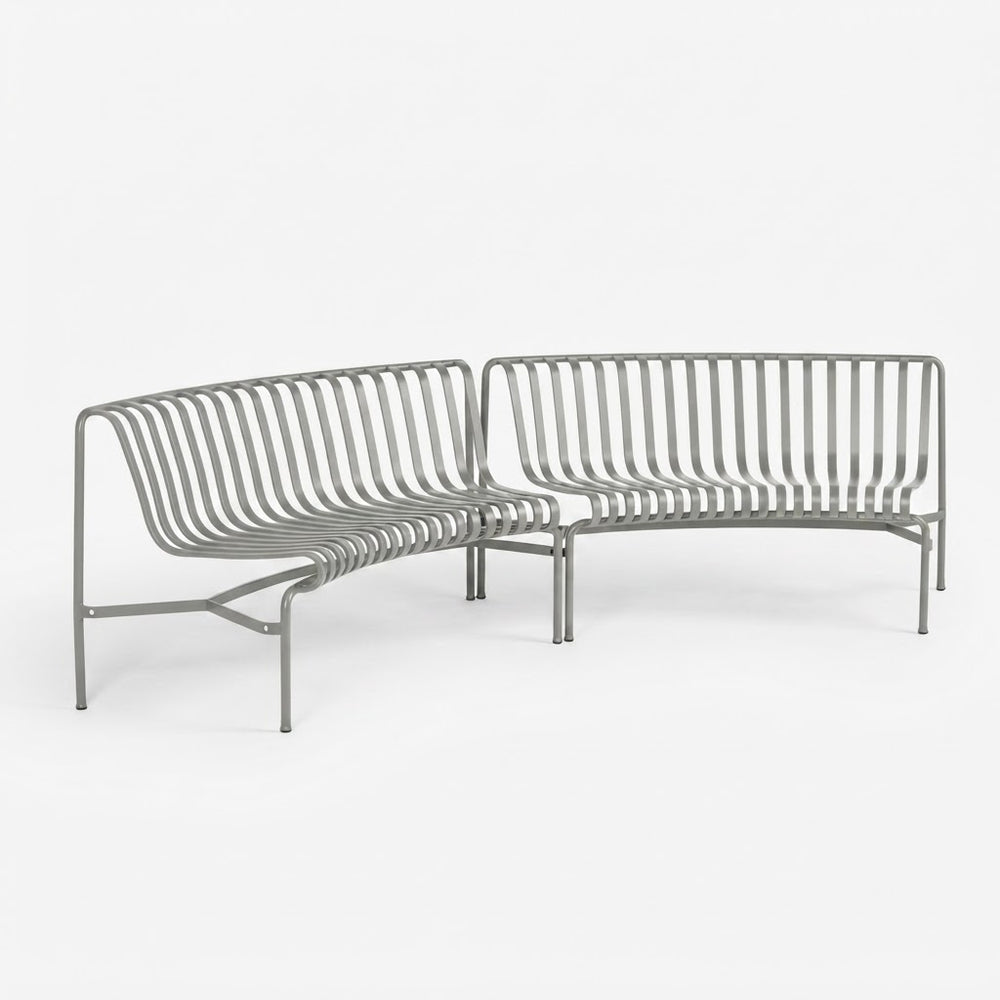 A modern gray metal slatted outdoor sofa with a curved left section and a straight right section, shown on a clean white background.