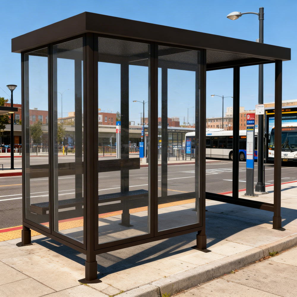 Empty modern bus stop shelter with flat roof, glass enclosure, and built‑in bench designed for public transportation stops.