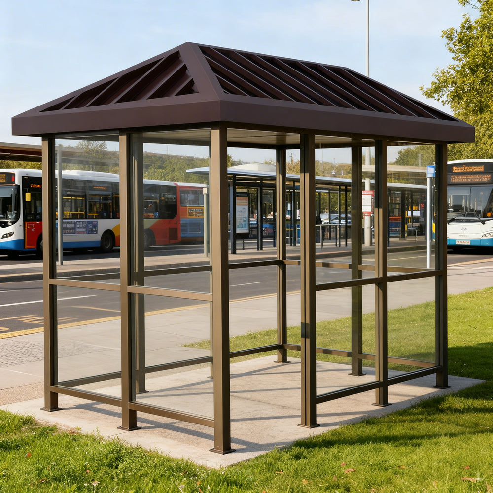 TAIMCO bus stop shelter installed outdoors with bronze frame and glass side panels for public transit use.