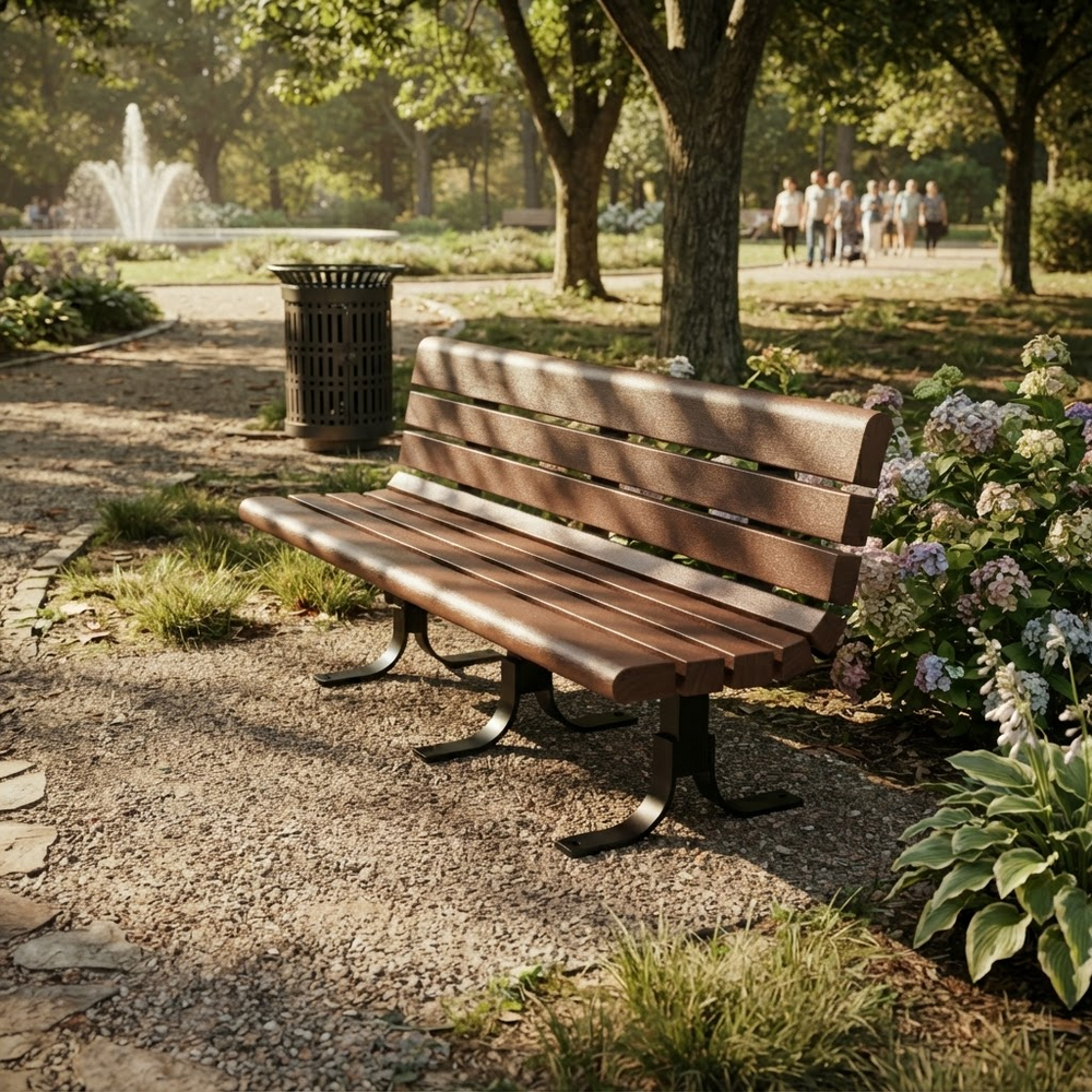 A wooden park bench with dark metal legs sits on a gravel path in a sunny park with trees, flowers, a fountain, and distant people walking in the background.
