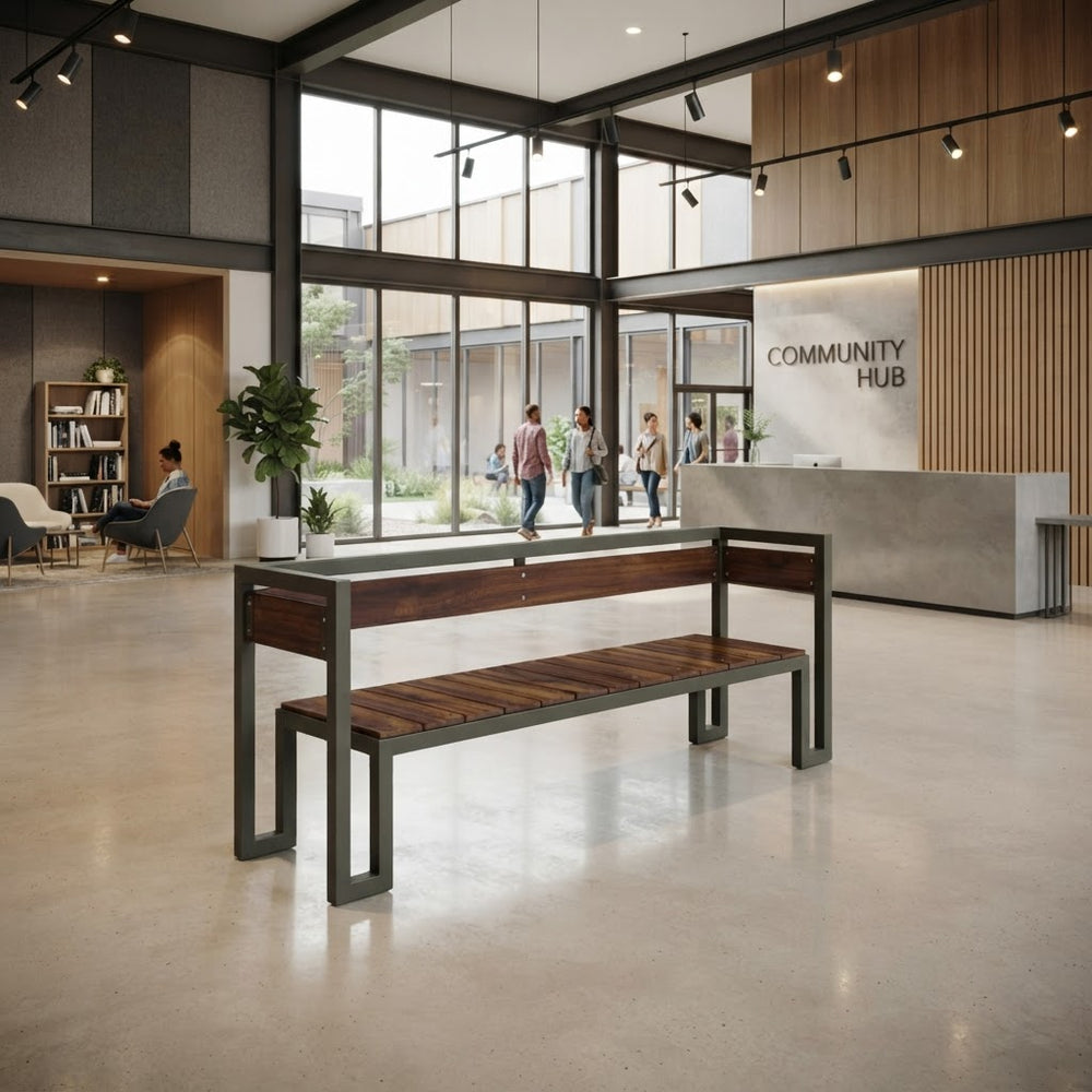 A modern wooden and metal bench is placed in a bright, contemporary community center lobby with large windows, a reception desk, and people walking in the background.