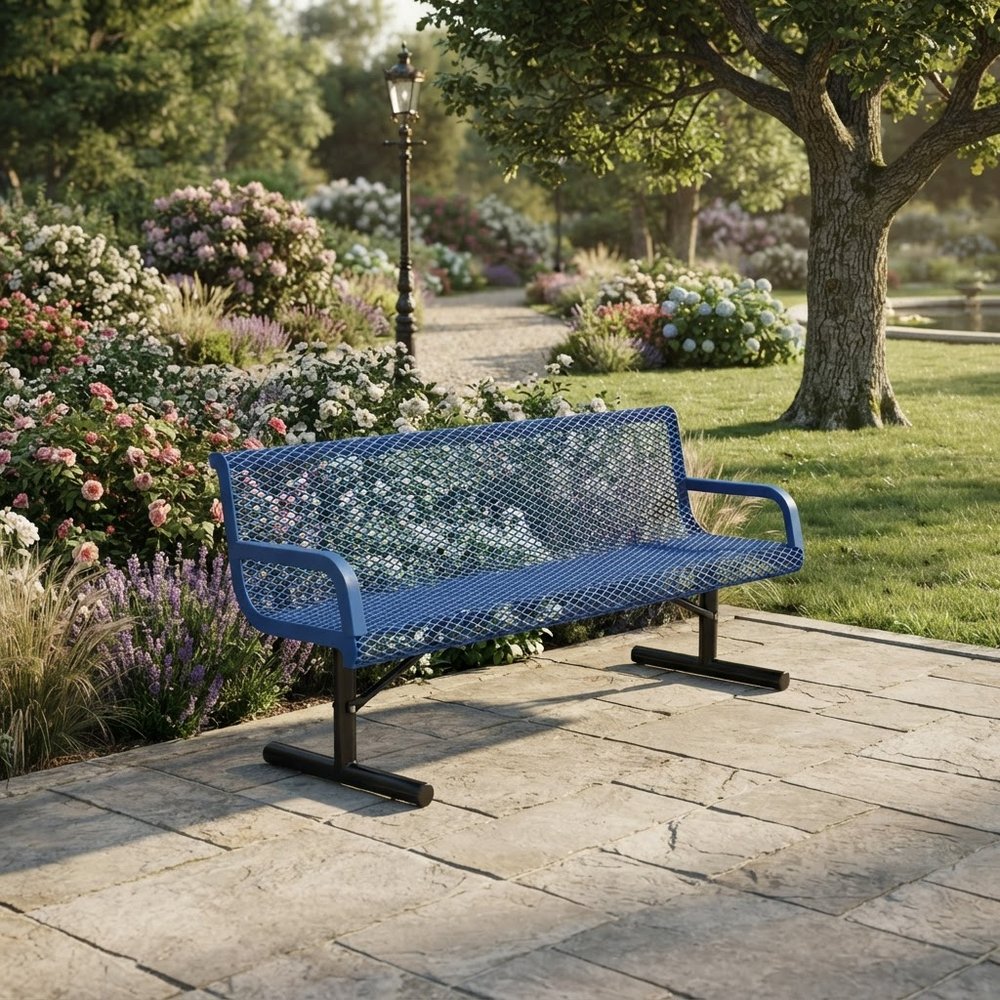 A blue metal mesh park bench with black legs, situated on a stone patio in a lush, sunlit garden with flowers, trees, and a lamppost.