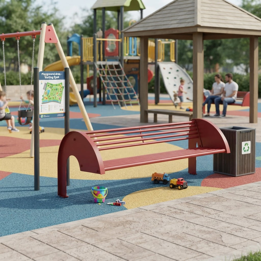 A red metal playground bench with curved ends is shown in a children's playground setting. The bench is positioned on a colorful rubberized safety surface next to a dark brown recycling bin, with playground equipment, a pavilion, and children visible in the background.