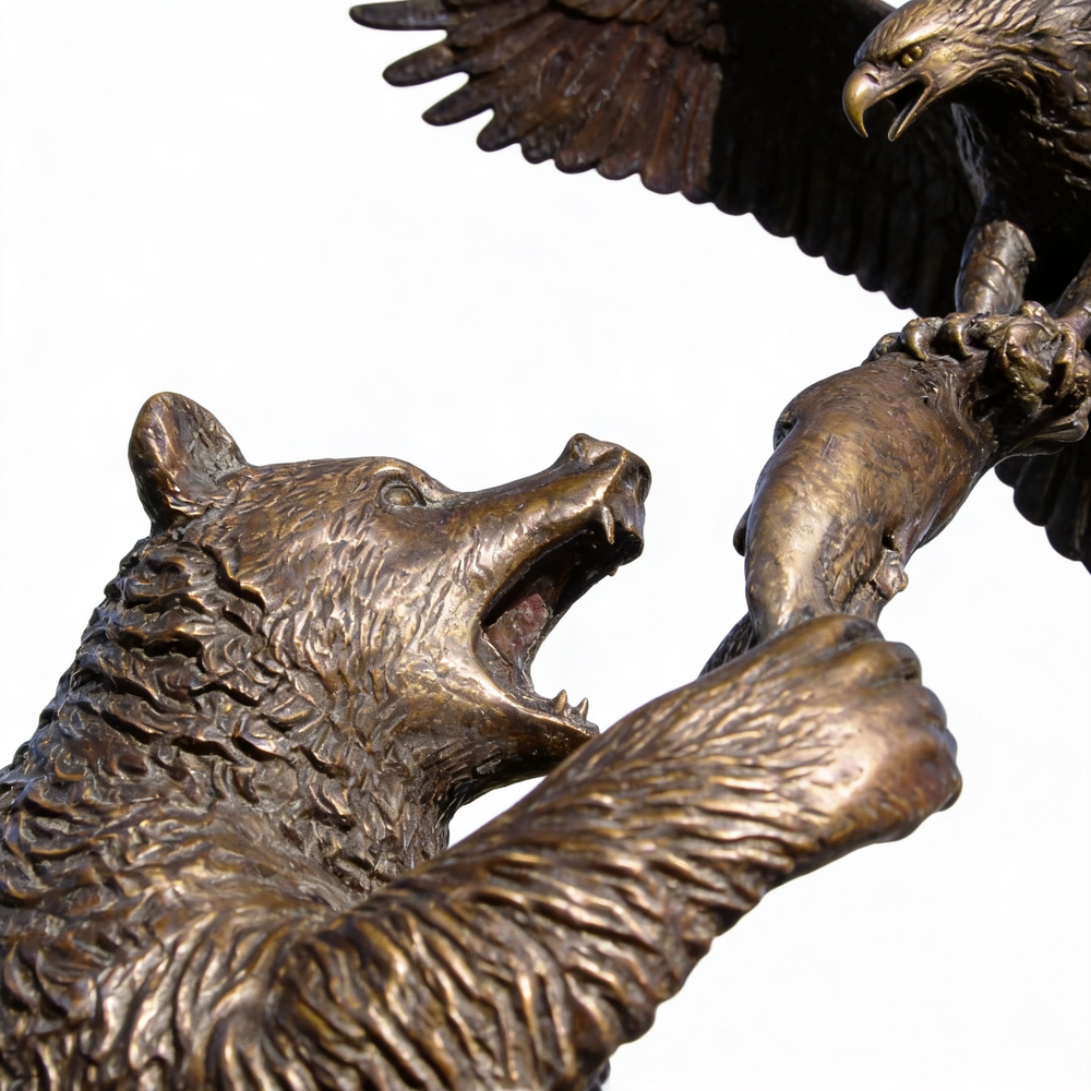 Bronze sculpture of a bear and an eagle on a white background