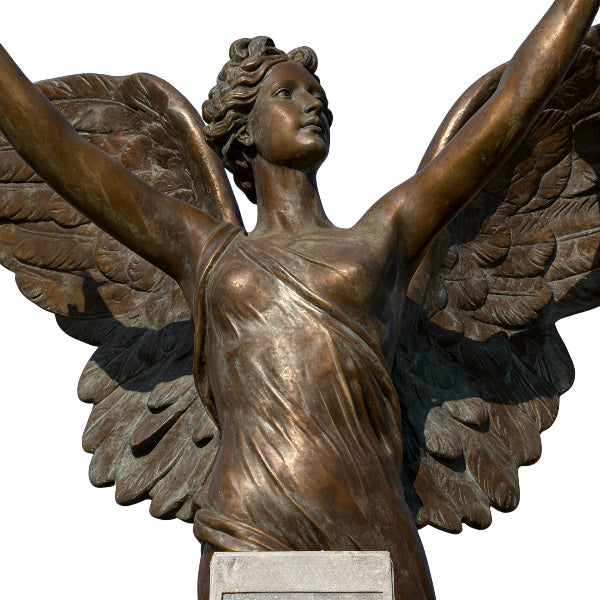 Bronze statue of an angel with outstretched wings on a white background