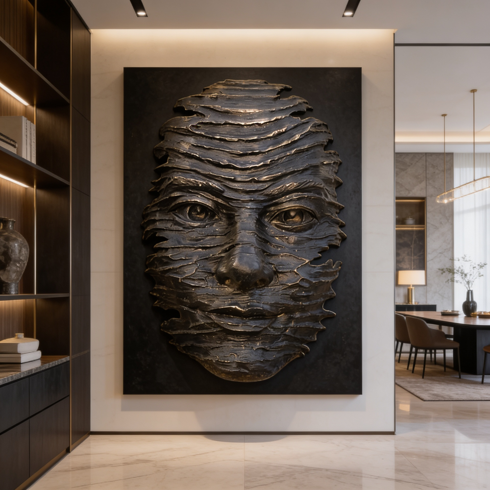 Decorative wall art of a textured face on a black background in a modern interior setting.