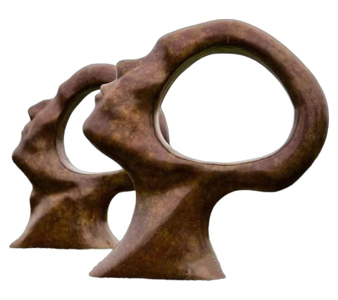 Bronze sculpture of two intertwined figures on a white background