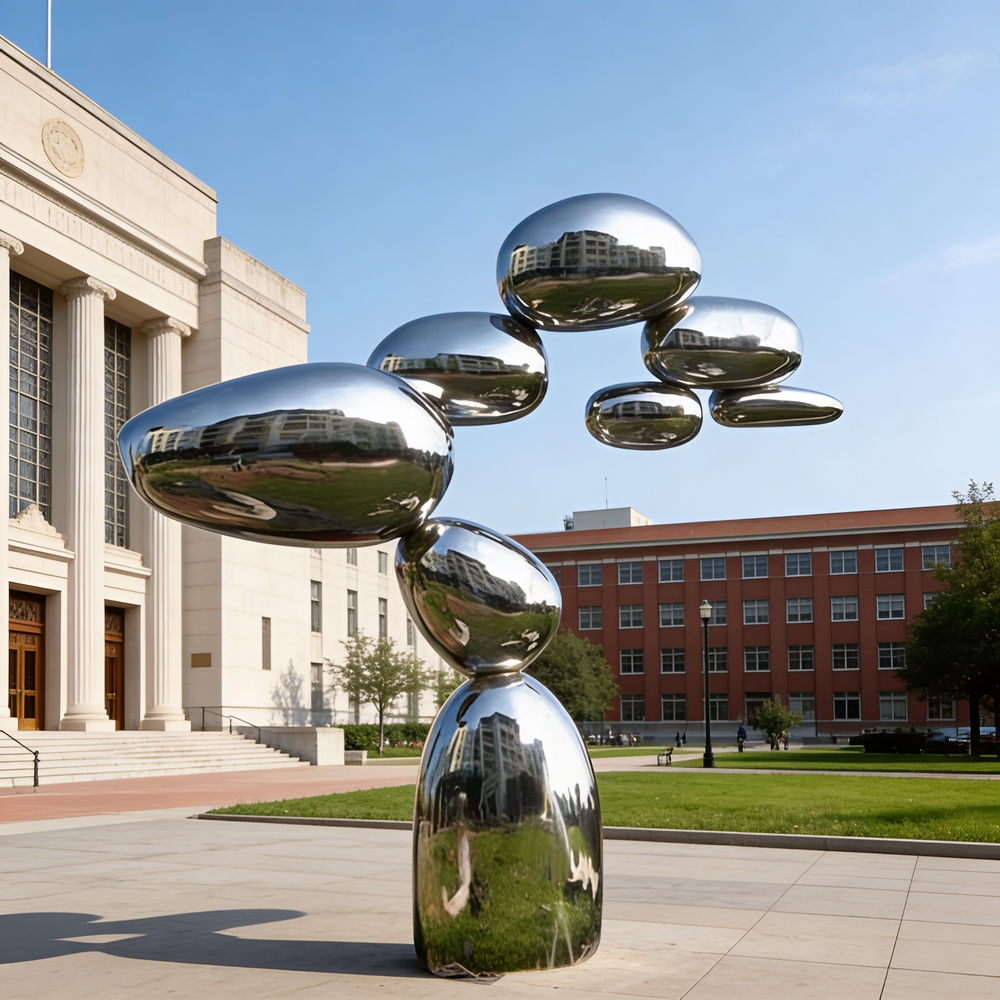 Abstract stacked‑form metal sculpture with smooth curved surfaces and reflective finish