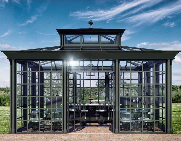 Glasshouse with a black frame against a blue sky