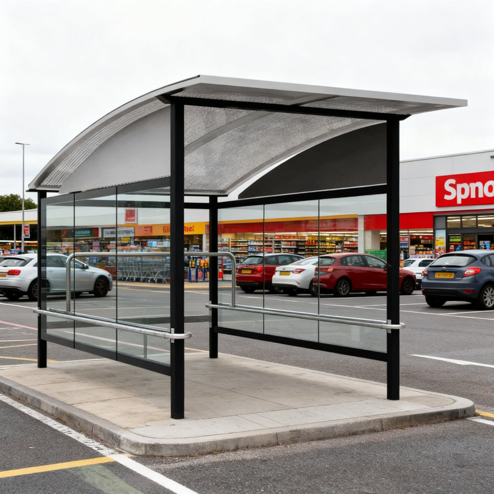 TAIMCO shopping cart shelter installed outdoors with curved metal roof and glass side panels.
