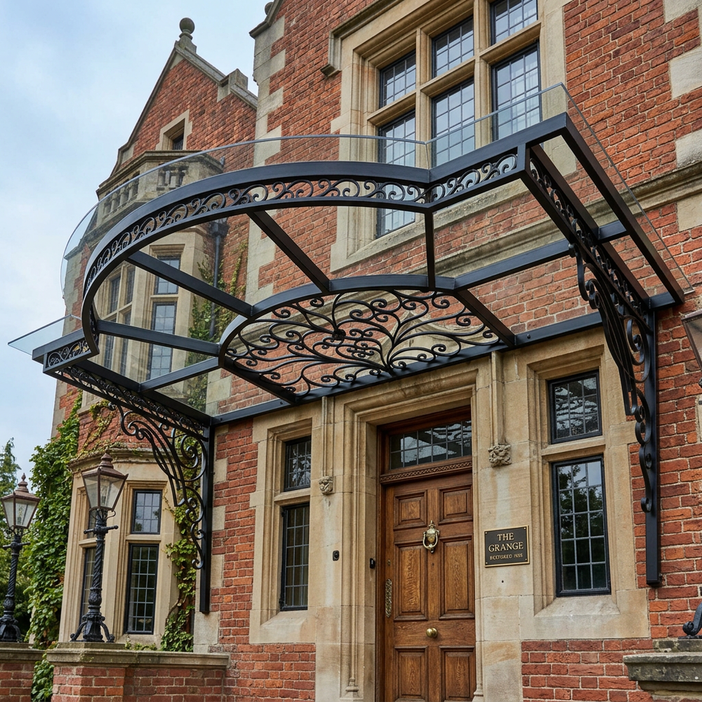 Decorative metal canopy over a wooden door of a large brick building.