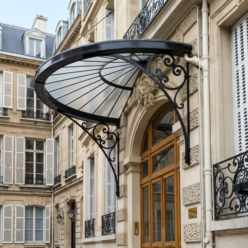 Heritage‑style iron canopy installed above wooden glass‑panel doorway.