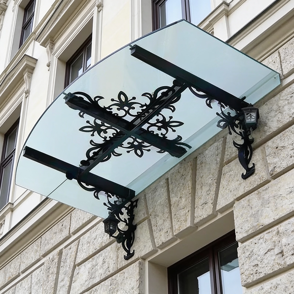 Wrought iron scrollwork awning with triple‑beam reinforcement and lantern lighting.