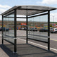 Tempered glass side panel on TAIMCO shopping cart shelter providing visibility and weather protection.