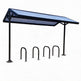Bicycle parking shelter with a blue roof and metal racks on a white background