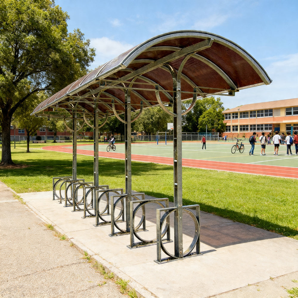 Side profile of outdoor bike shelter featuring arched roof and multiple bicycle locking hoops.