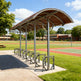 Black steel frame and welded supports on TAIMCO covered bike parking shelter.