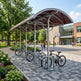Rear angle of bike parking shelter with curved roof and open‑air design.