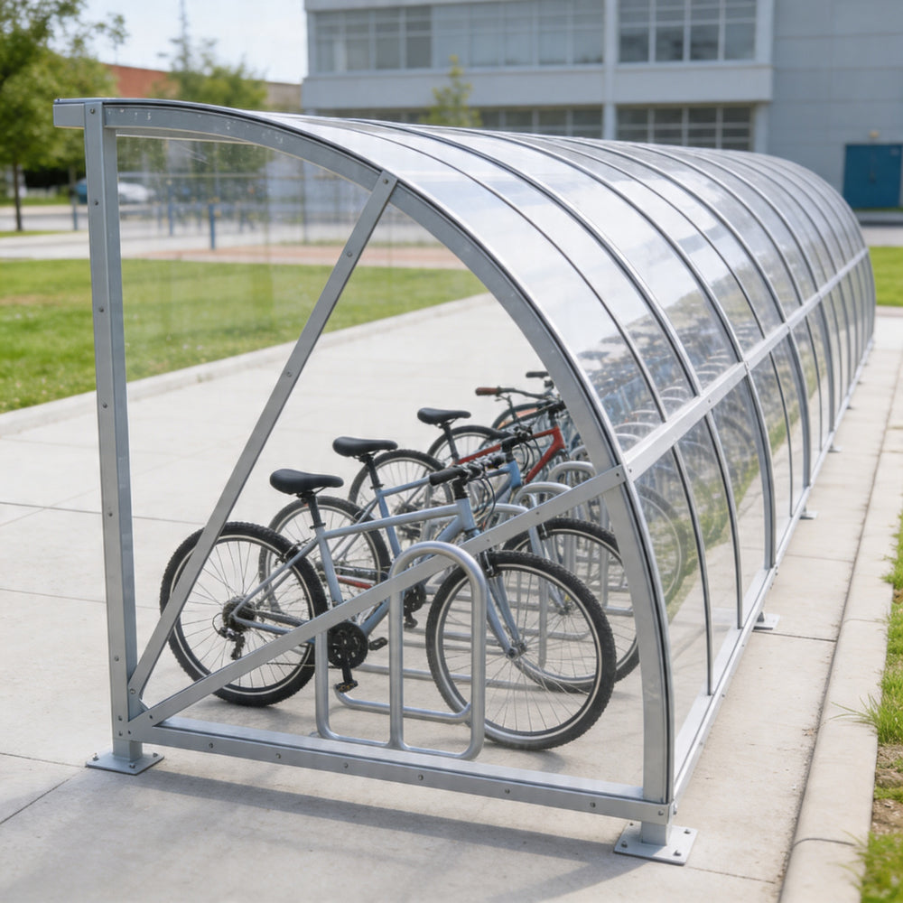 Bicycle shelter with multiple bicycles parked inside on a sidewalk.