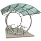 Decorative metal and glass sculpture on a white background