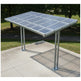 carport structure on a concrete surface with grass and trees in the background