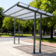 Solar panel canopy on a sidewalk with trees and people in the background