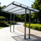 carport structure in an outdoor setting with trees and a clear sky.