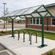 Bicycle shelter with bike racks in front of a building