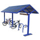 Blue bike shelter with bicycles underneath on a white background