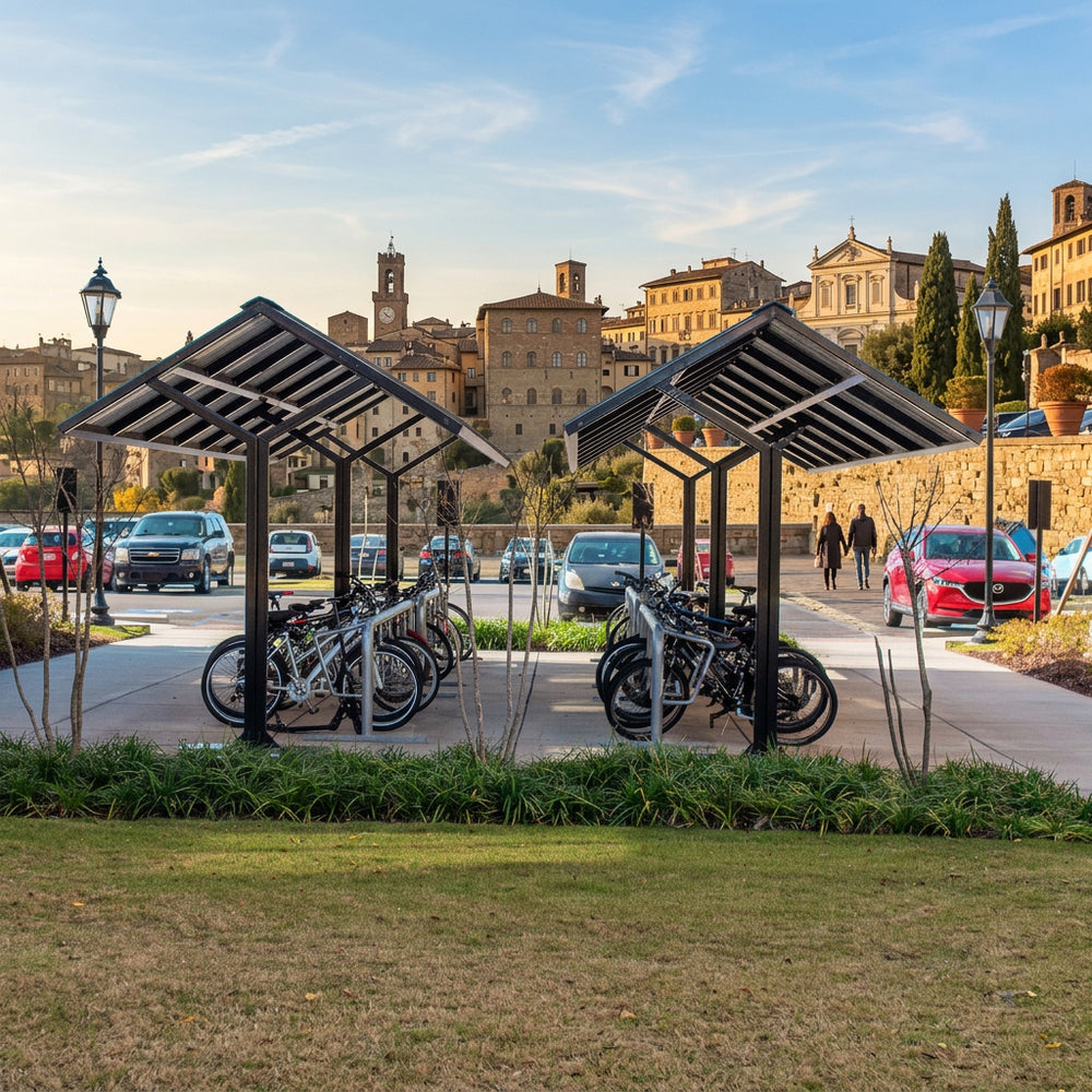 Bicycle parking area with covered shelters in a cityscape with historic buildings.