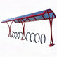 Red bicycle shelter with multiple bike racks on a white background
