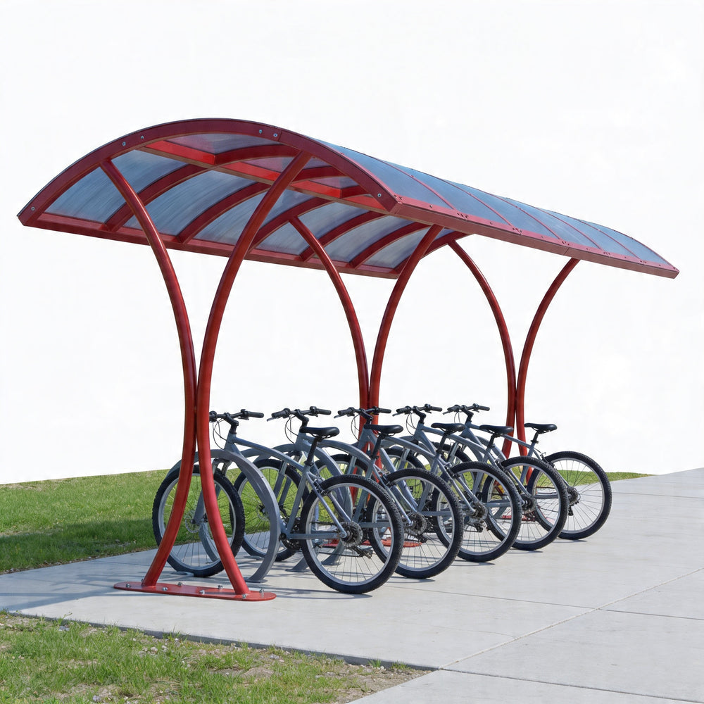 Red bicycle shelter with multiple bicycles parked underneath on a clear day.