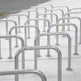 Row of metal bike racks on a concrete surface