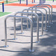 Row of metal bike racks on a concrete surface