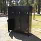 Black metal locker with open door in a outdoor setting