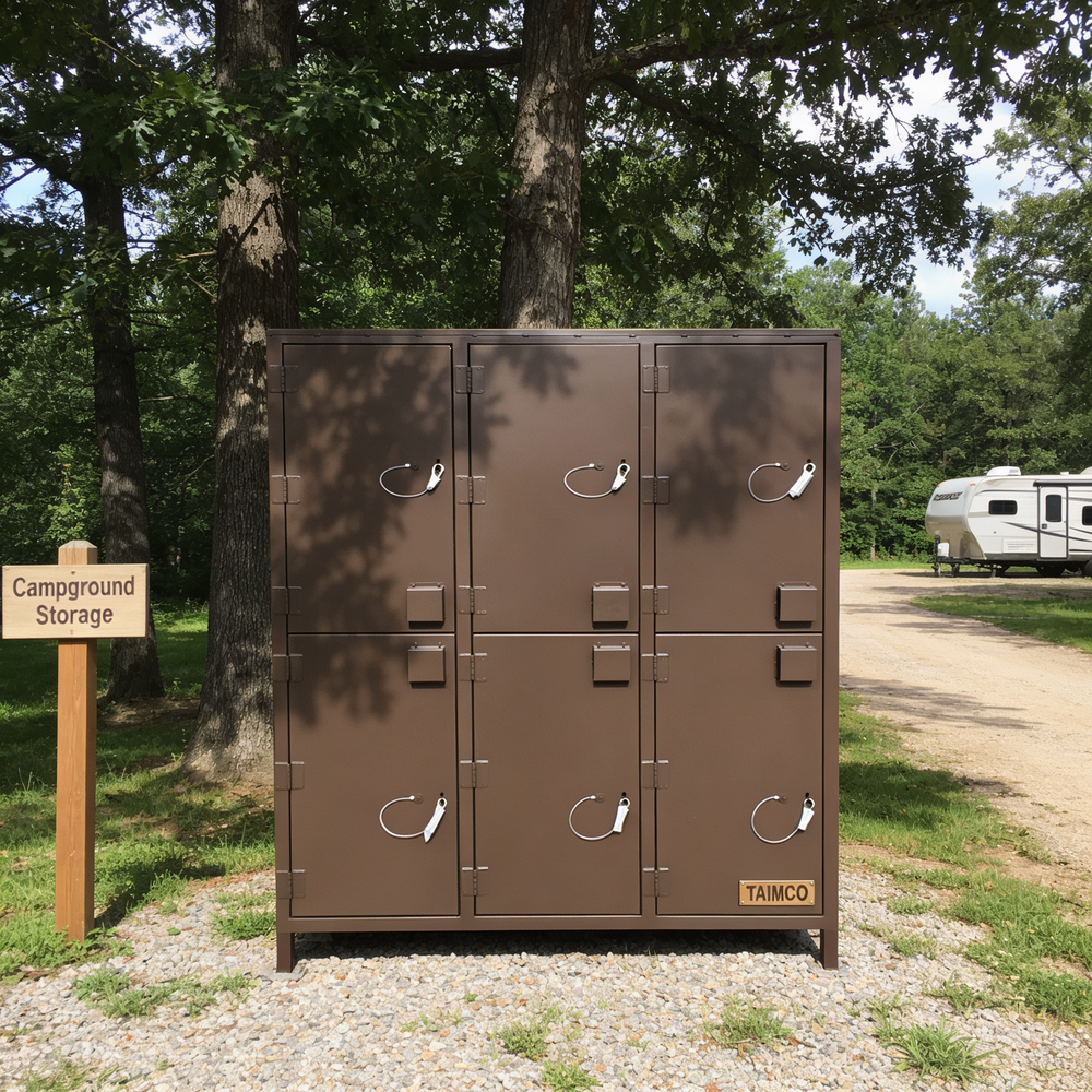 Brown campground storage lockers with a sign in a wooded area