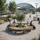 A modern outdoor train station plaza with curved wooden benches, people sitting and using their phones, a central tree in a planter, and a train arriving under a glass canopy.