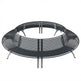 A round outdoor fire pit table with a dark gray metal slatted seat and silver-colored legs, shown on a solid white background.