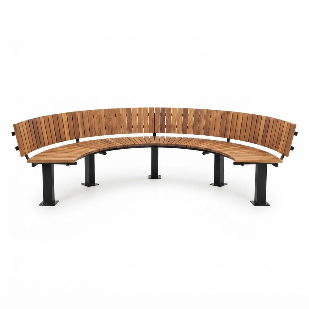 A curved outdoor bench with a warm brown wooden slatted seat and backrest, supported by four black metal legs, shown on a plain white background.