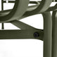 Close-up detail of an olive green metal outdoor chair frame, showing a black hex screw fastening a horizontal support bar to a vertical leg, against a white background.
