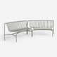 A modern gray metal slatted outdoor sofa with a curved left section and a straight right section, shown on a clean white background.