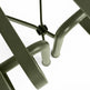 Close-up detail of an outdoor patio table frame in a matte olive green finish, showing the central joint and leg structure against a solid white background.