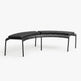 A modern curved outdoor bench with a black metal frame, featuring a slatted backrest and thick black cushioned seat pads, shown against a plain white background.