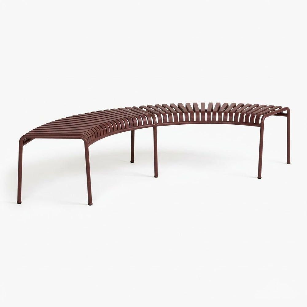 A curved outdoor bench with a dark brown slatted seat and slim metal legs, shown on a clean white background.