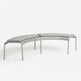 A modern curved outdoor bench with a light gray woven sling seat and matching cushioned backrest, supported by a slim silver metal frame, shown on a seamless white background.